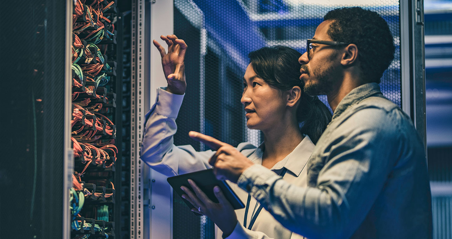 IT professionals evaluate a server rack in a data center
